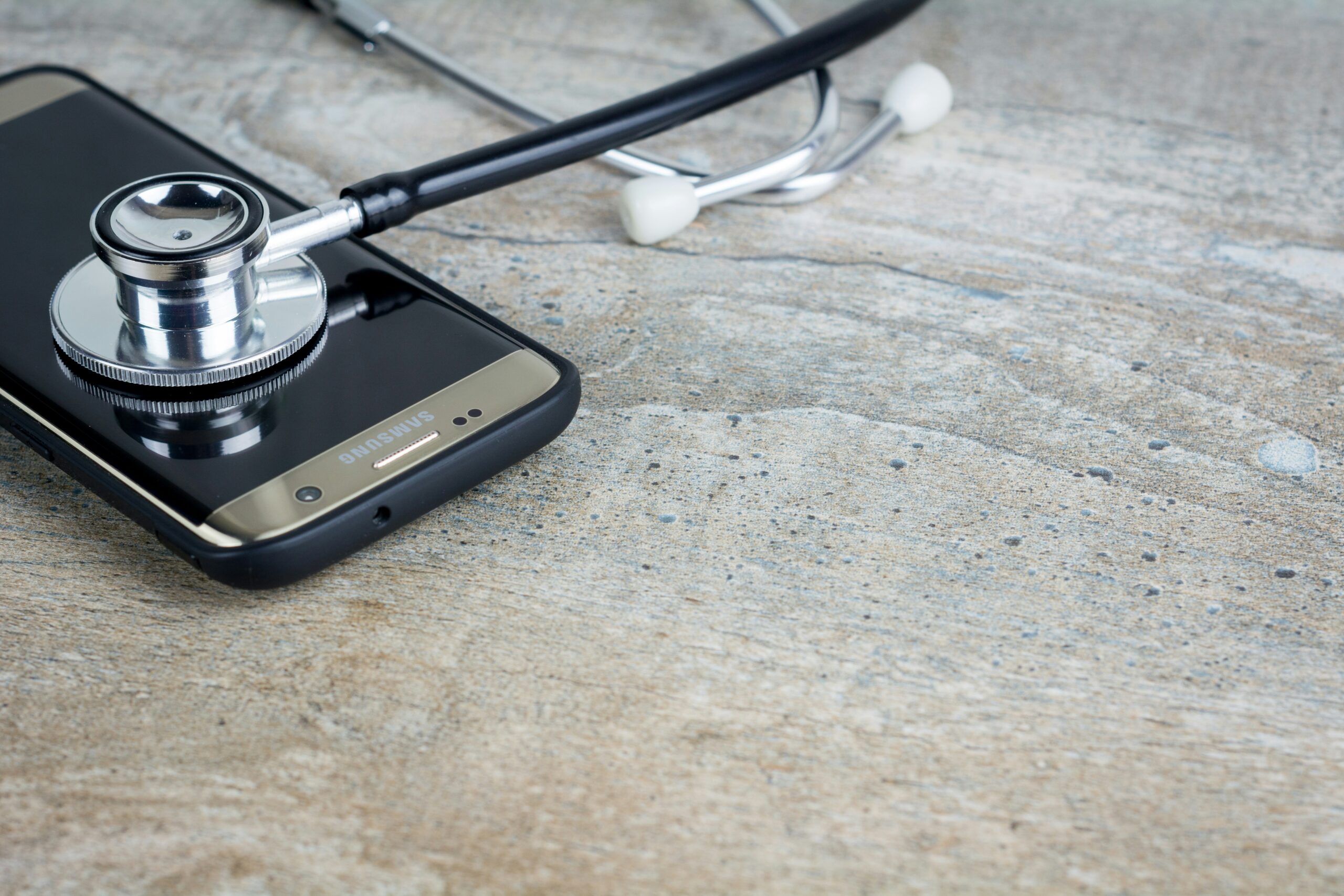 How to Fix Freezing or Slowness Problems on Your Smartphone a phone with a stethoscope on top of it