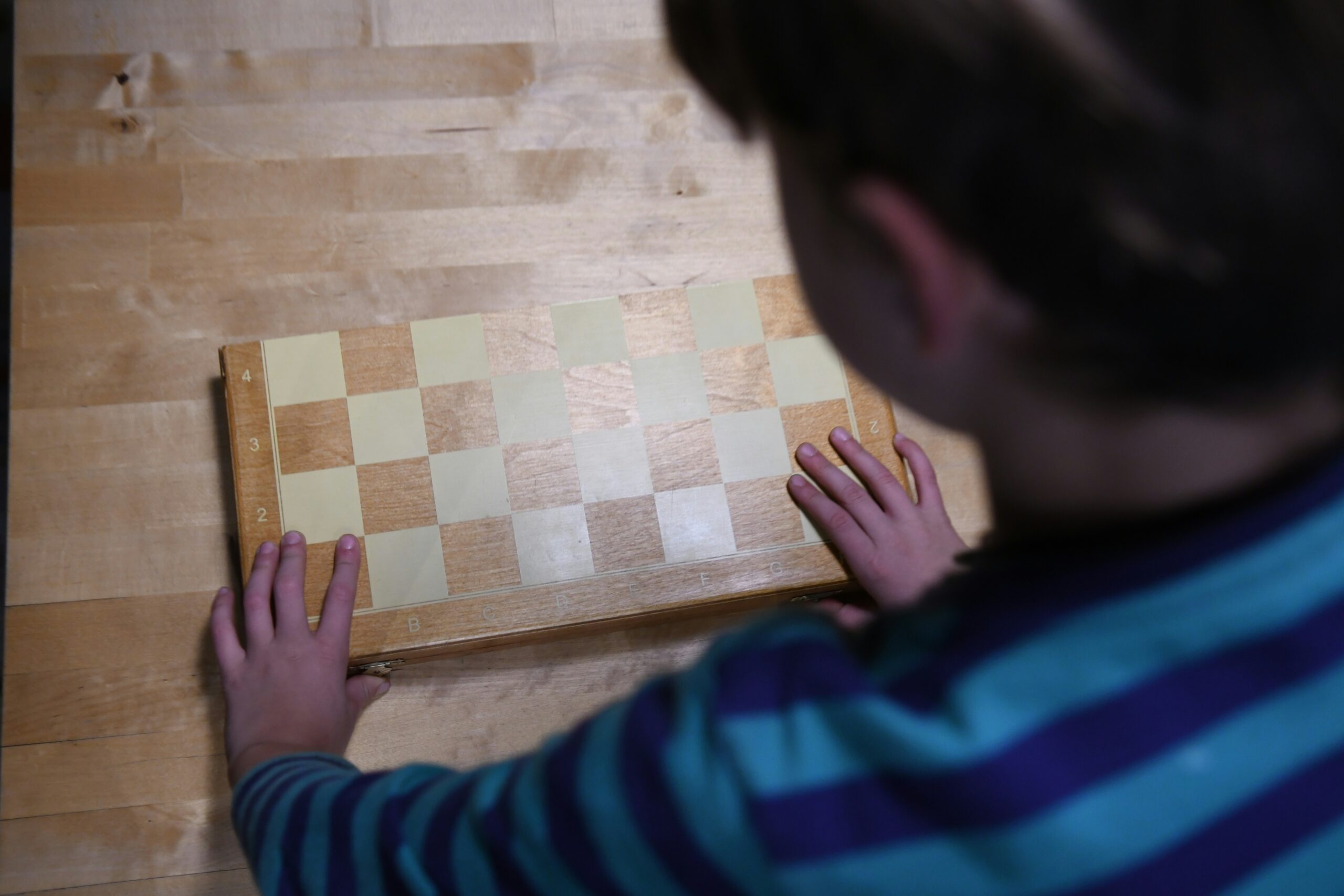 Games Chess: A Comprehensive Guide on How to Play and Where to Play boy in blue and black striped long sleeve shirt