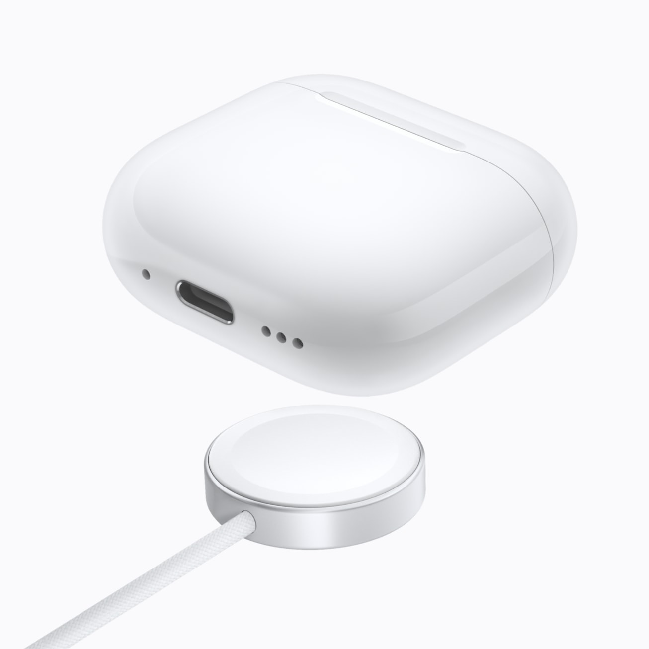 AirPods 5 with Wireless Charging Case are pictured above a charger.