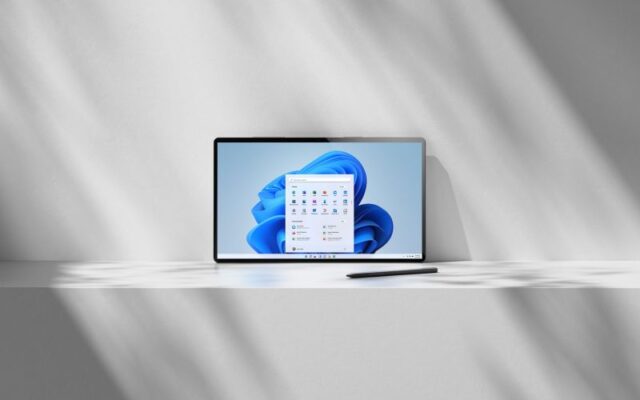Photo of tablet device with Windows 11 desktop rendered on screen