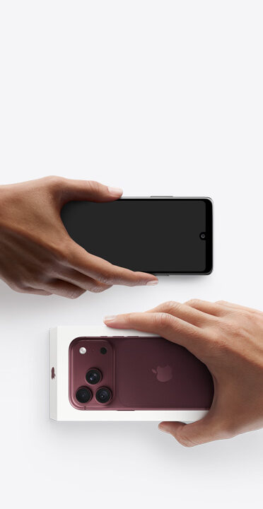 Hands exchanging phones, Android on the left without box, new iPhone 18 Pro, burgundy color (dark red), in box, on the right
