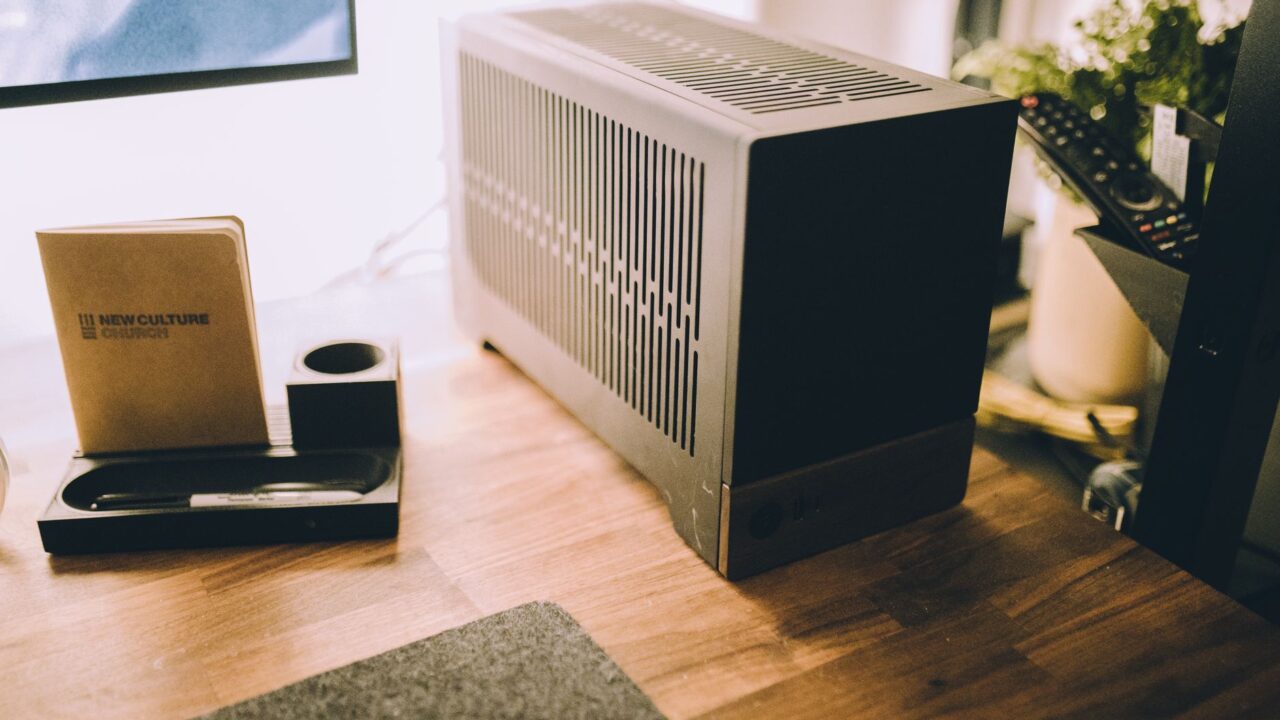 Sleek and stylish home office desk featuring a modern computer, notepad, and decor.
