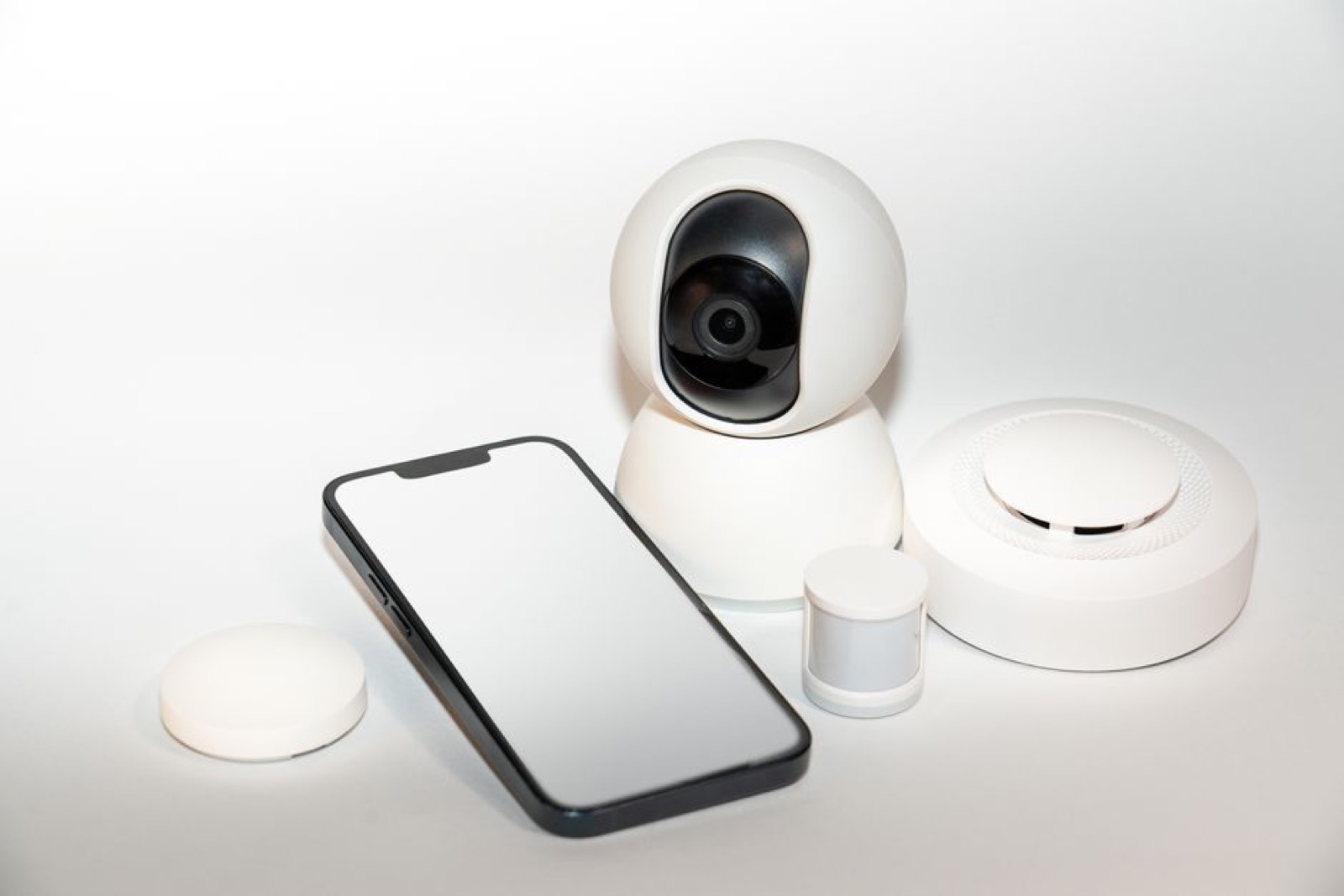 Smart home security devices next to a smartphone
