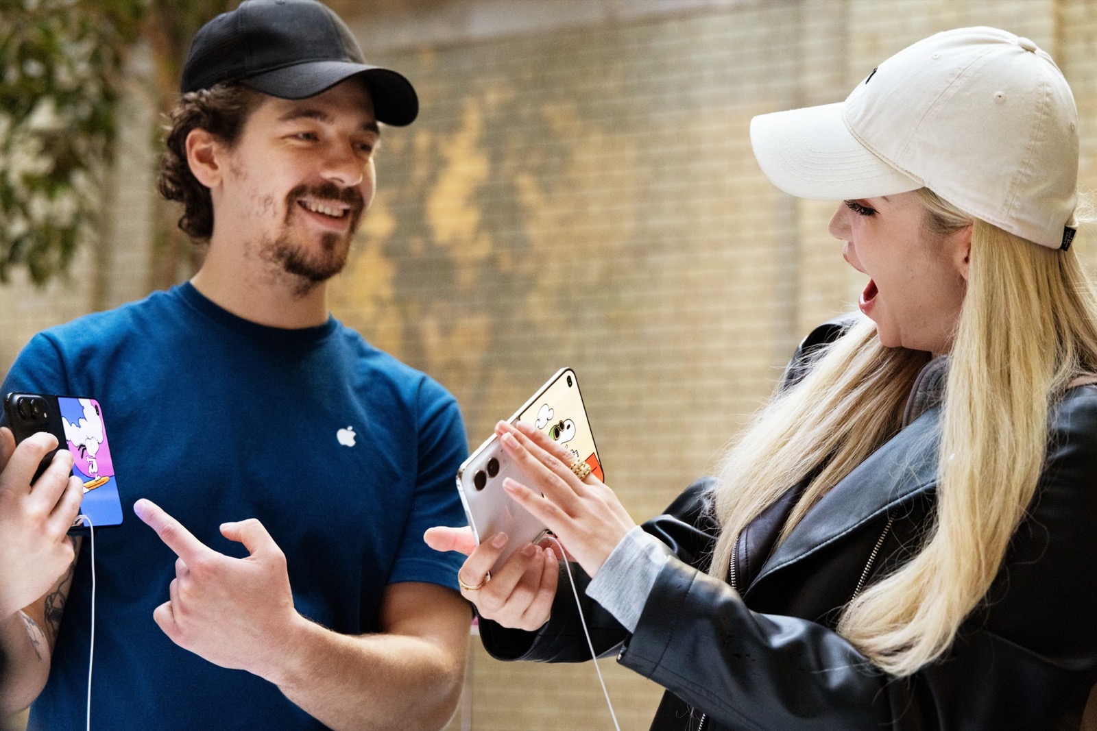 An Apple Store team member helping a customer with an iPhone Duo