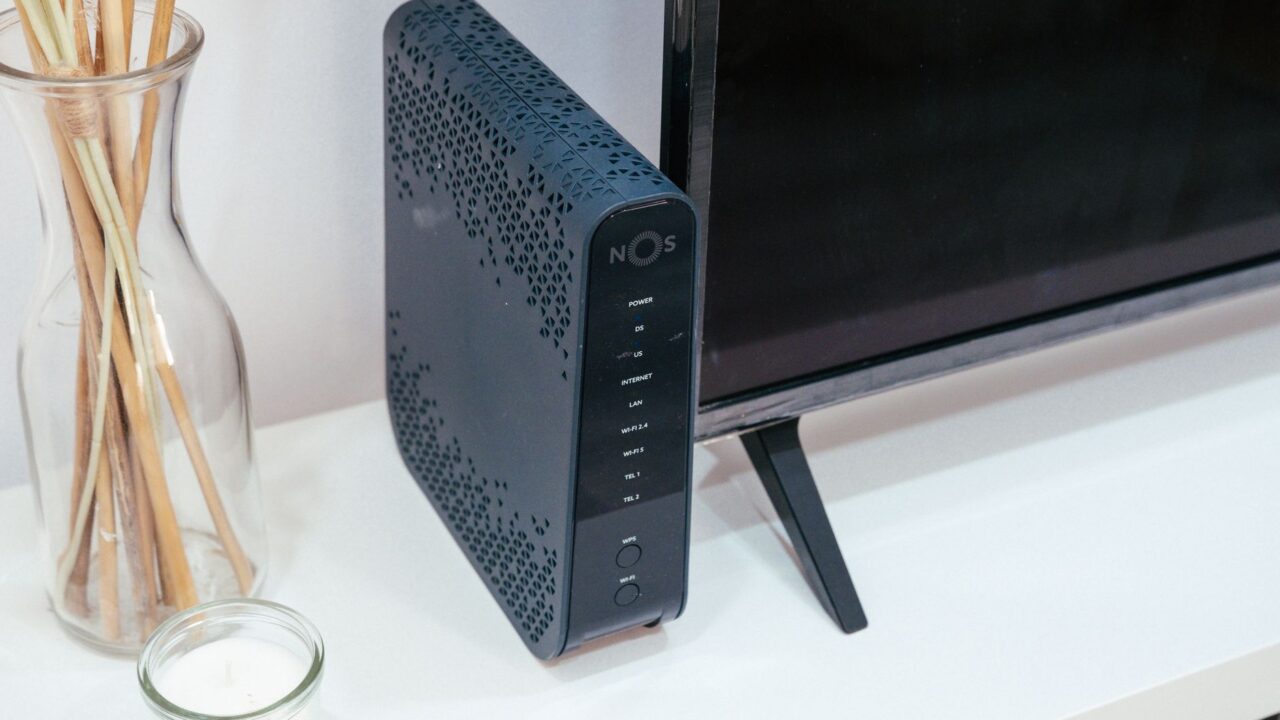 A sleek home technology setup featuring a router, glass decoration, and television.
