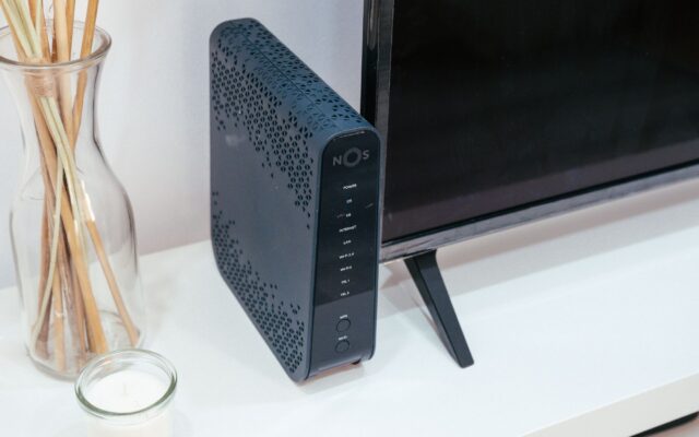 A sleek home technology setup featuring a router, glass decoration, and television.