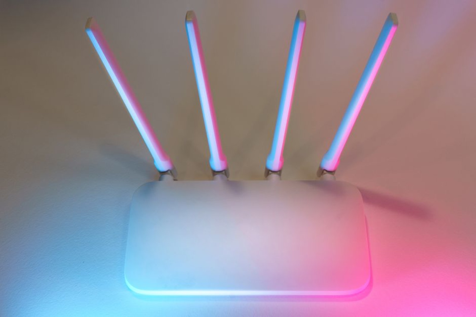 A white wireless router with four antennas