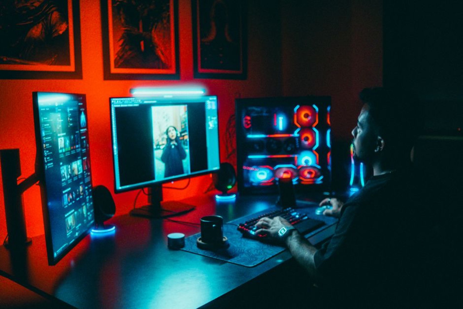 A man working on a multi-screen computer setup