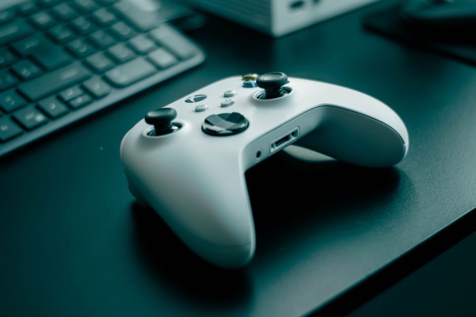 A white game controller on a desk
