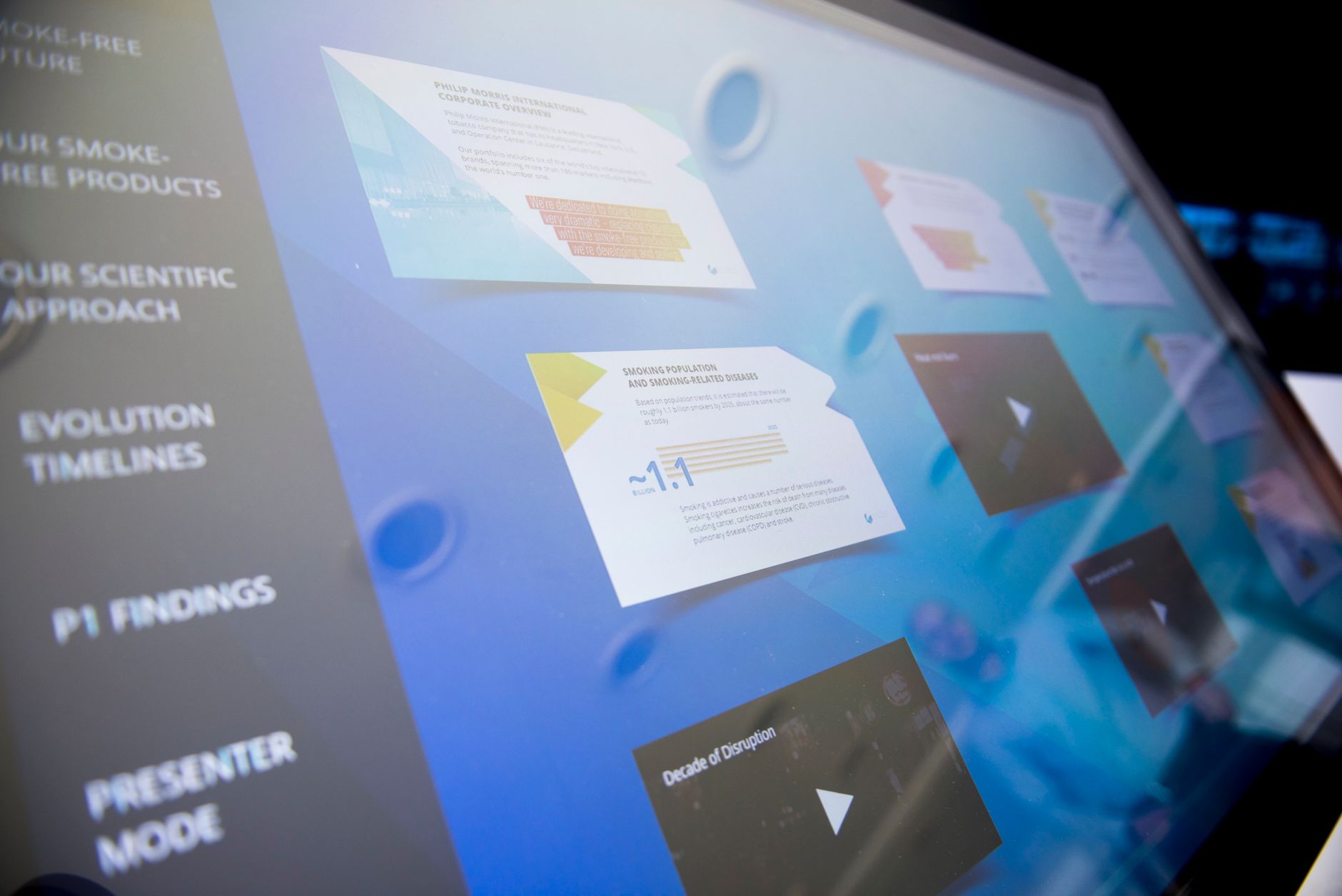 A touchscreen showing interactive data cards