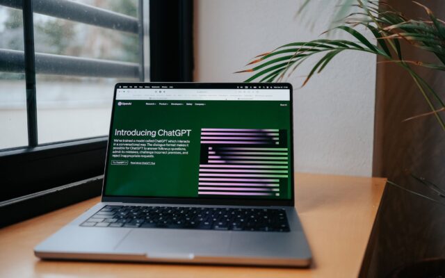 Laptop on a desk showing the ChatGPT website