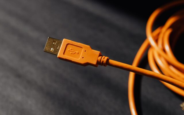 Detailed macro photo of an orange USB cable connector with focus on texture.