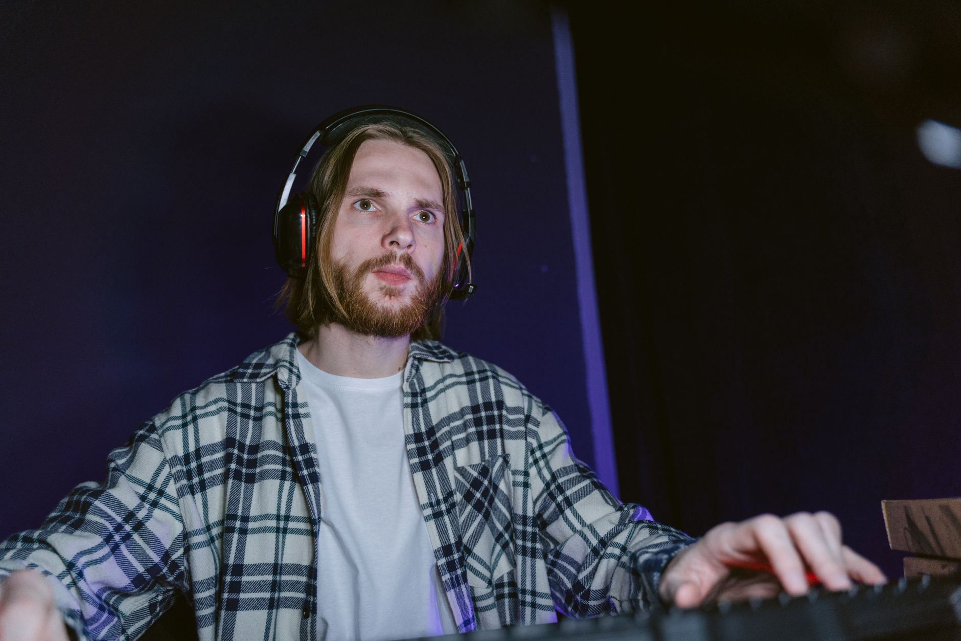 A man wearing a headset while playing a game