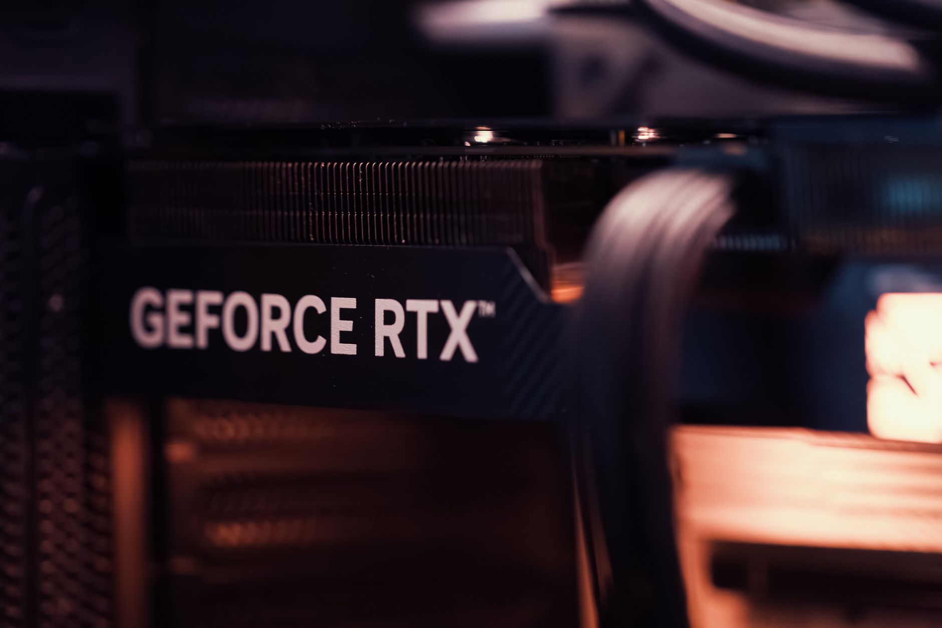 A GeForce RTX graphics card lit up inside a gaming PC