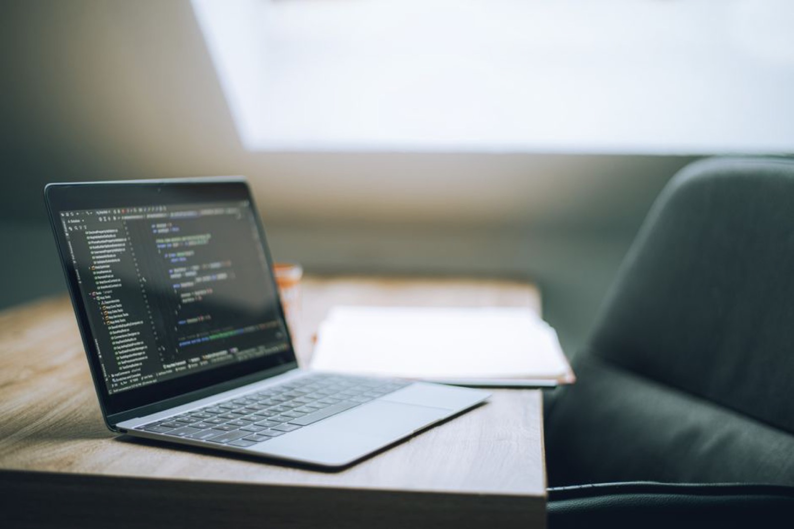 An open laptop showing code on a desk