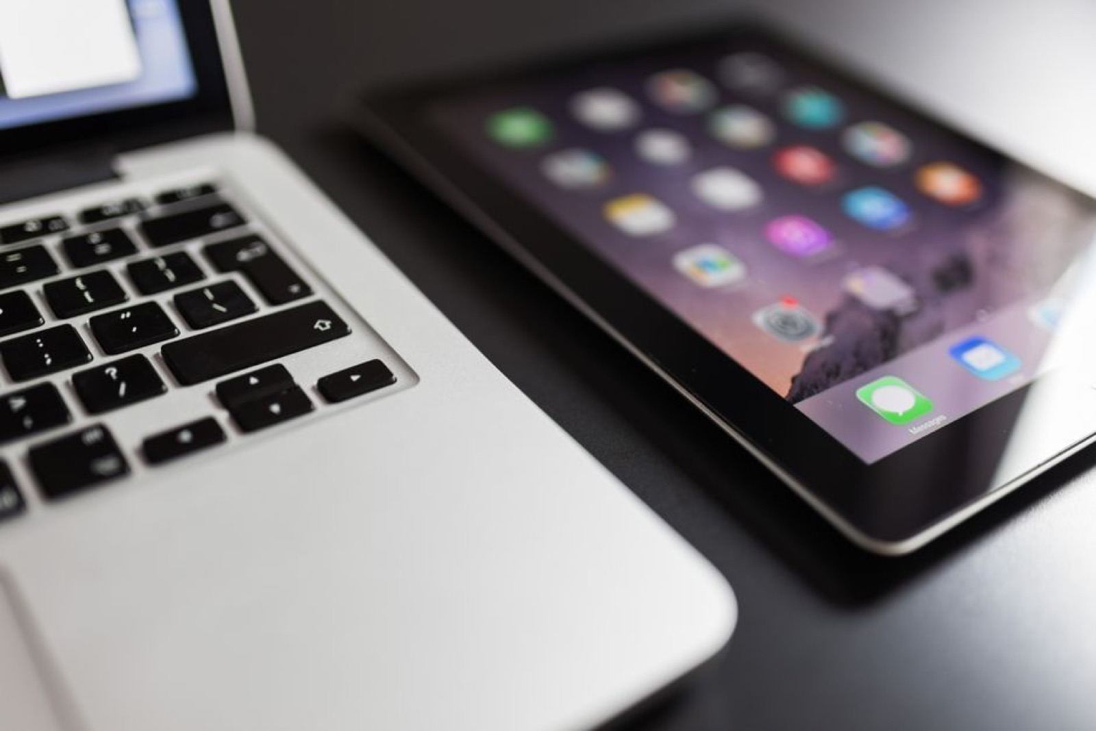 A laptop and a tablet on a desk