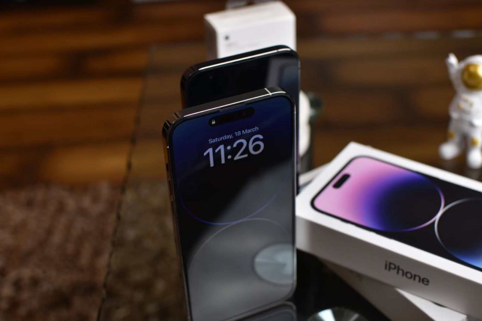 An iPhone 14 Pro next to its box