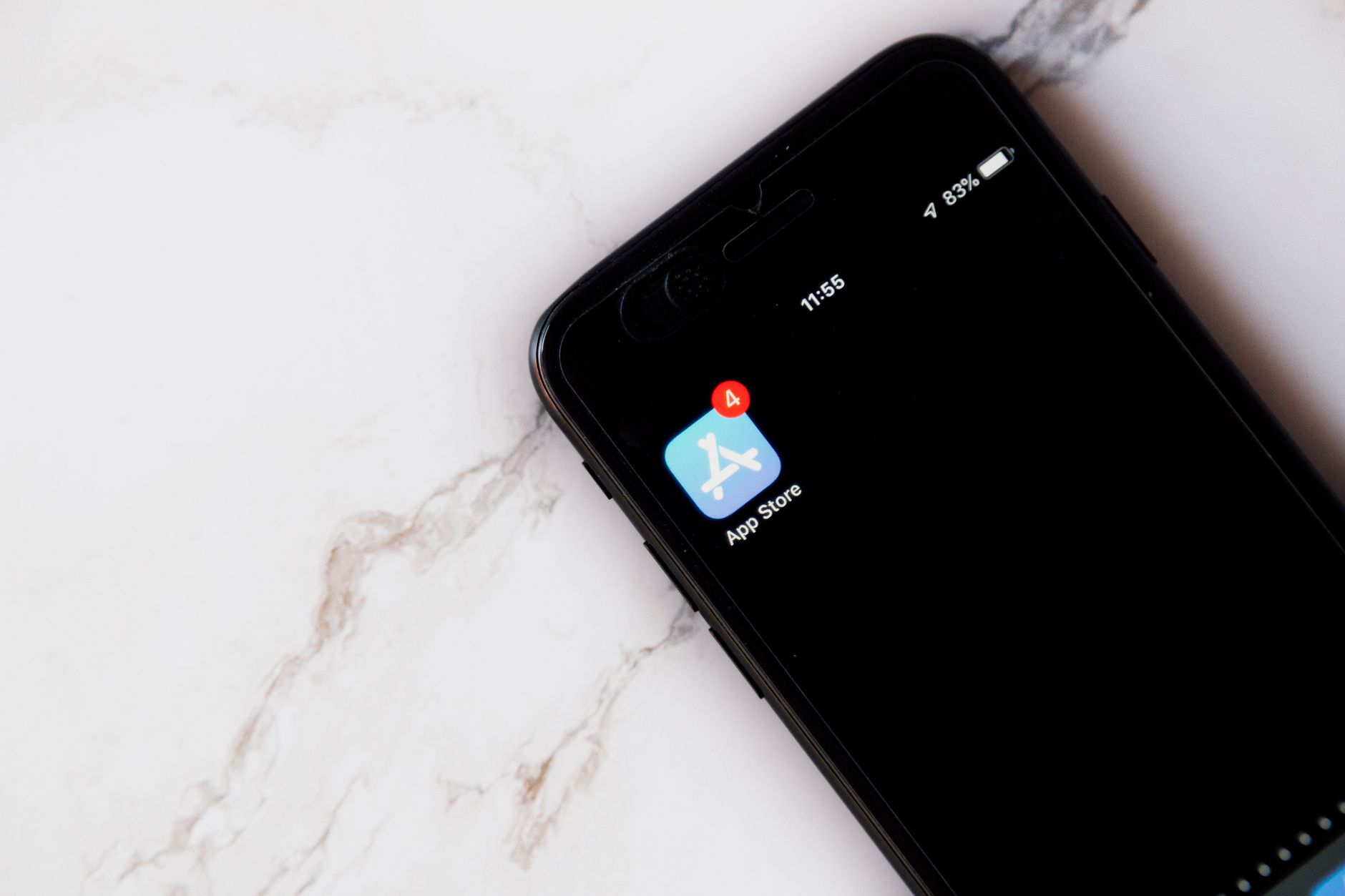 An iPhone showing the App Store icon with a notification badge