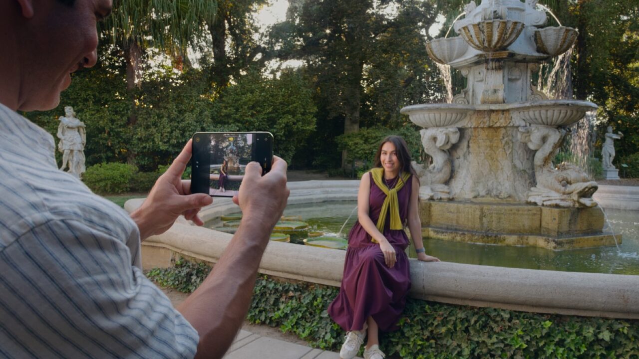 A person using an unfolded iPhone Duo to take a photo