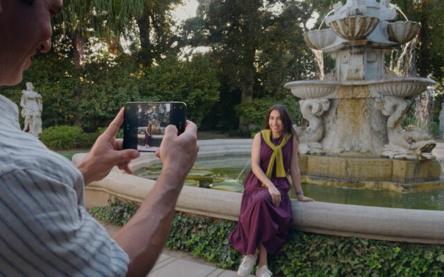A person using an unfolded iPhone Duo to take a photo