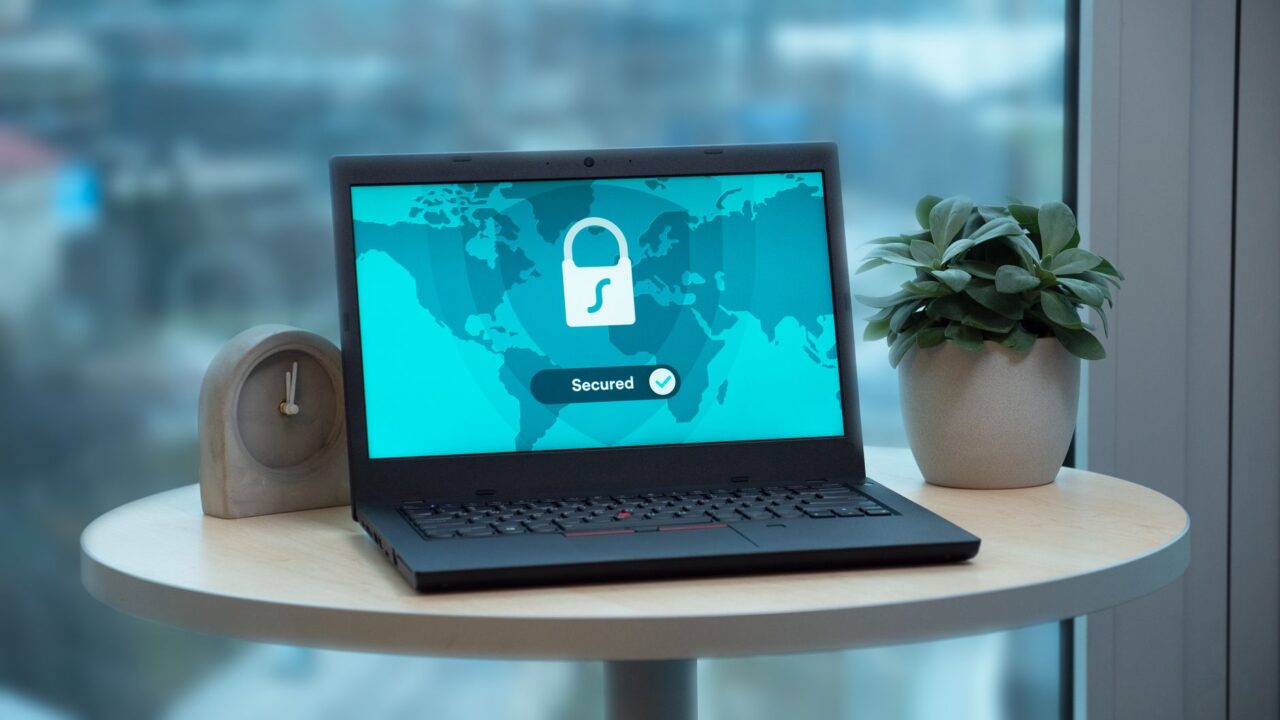 A laptop showing a security lock icon on a table
