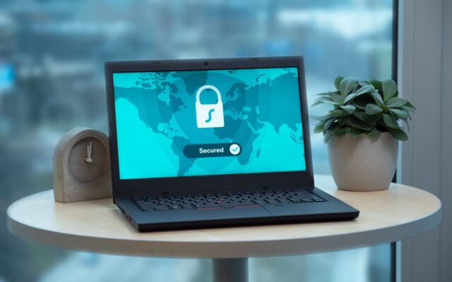 A laptop showing a security lock icon on a table