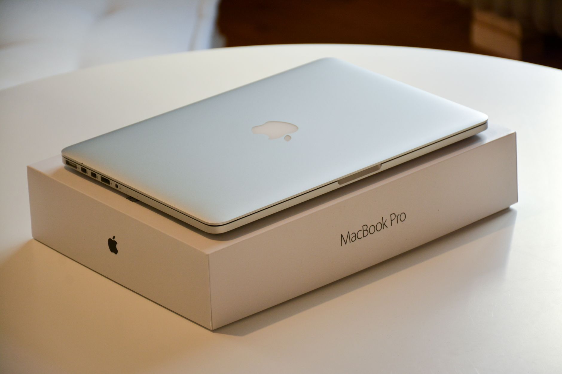 A MacBook Pro resting on its retail box