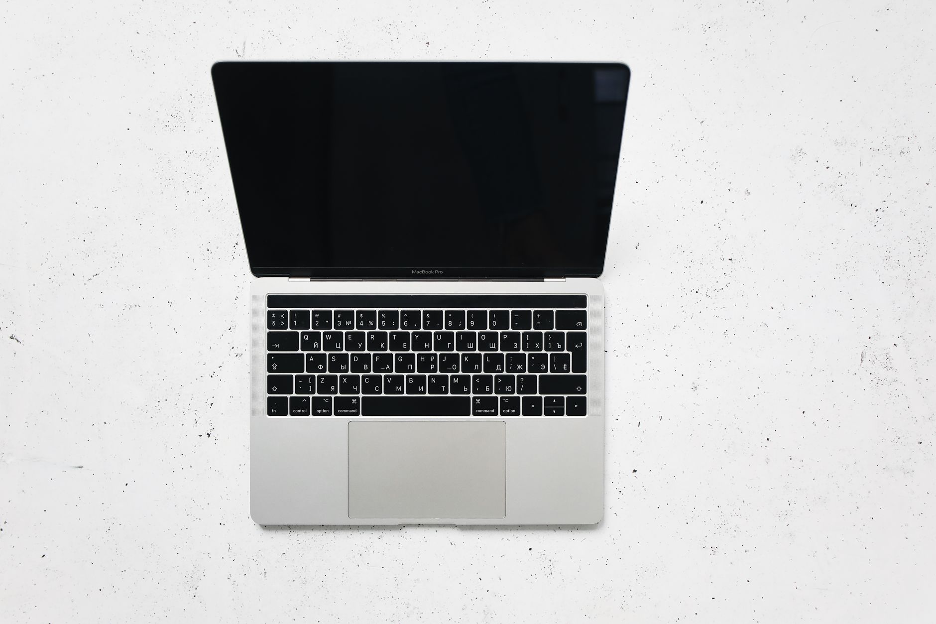 An open MacBook Pro seen from above on a marble surface