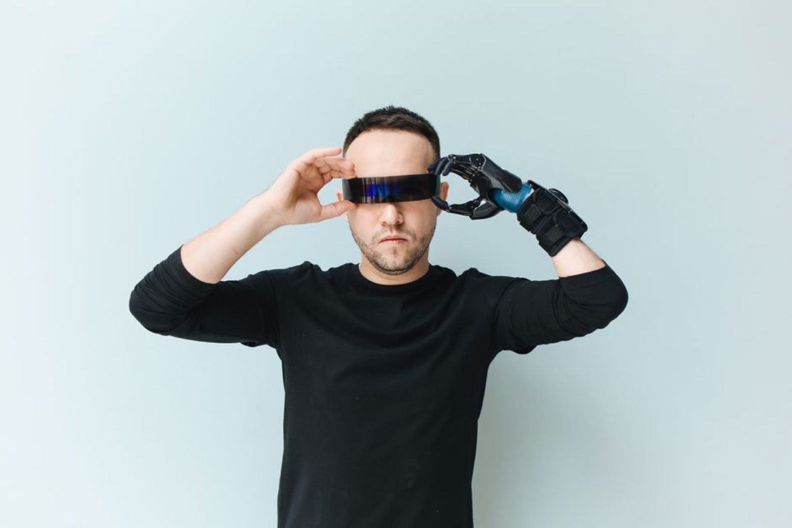 A man adjusting futuristic smart glasses