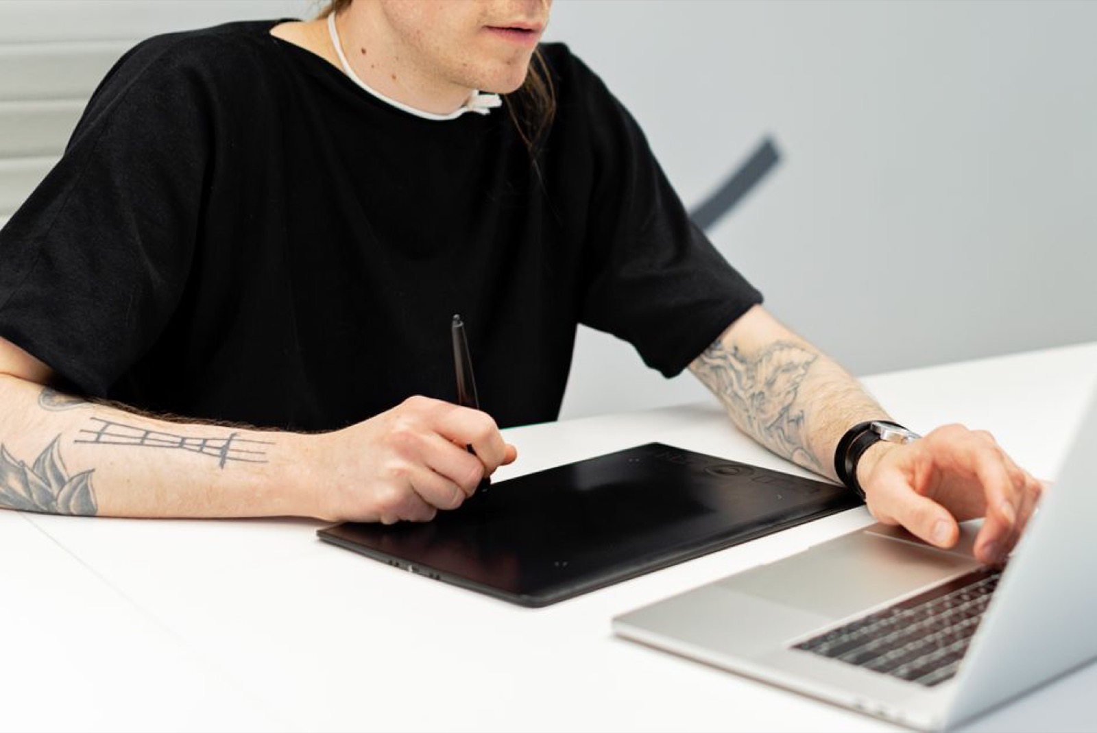 An artist drawing on a graphics tablet
