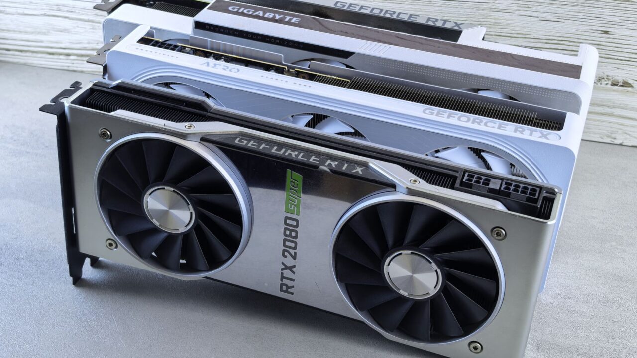 Three Nvidia GeForce RTX graphics cards stacked on a table