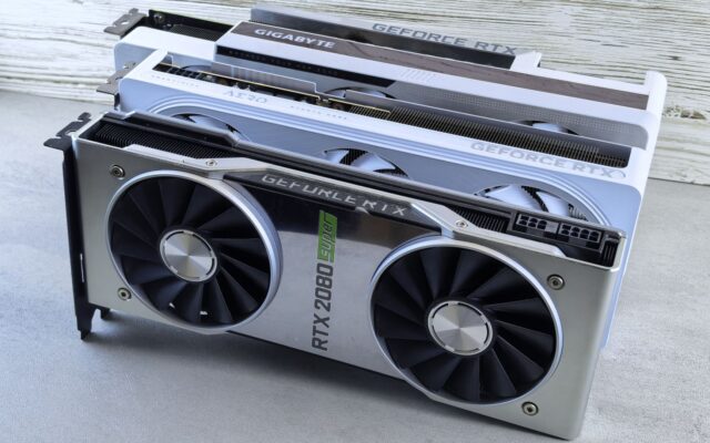 Three Nvidia GeForce RTX graphics cards stacked on a table