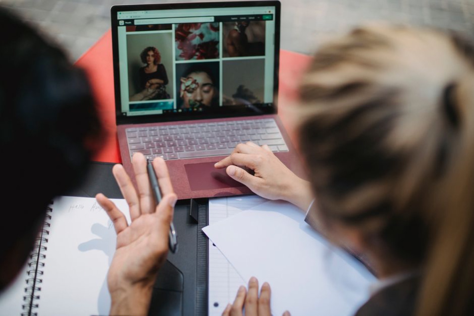Two people collaborating over a laptop