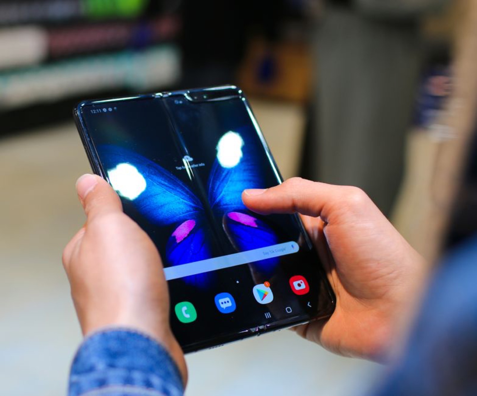 Hands holding an open foldable smartphone