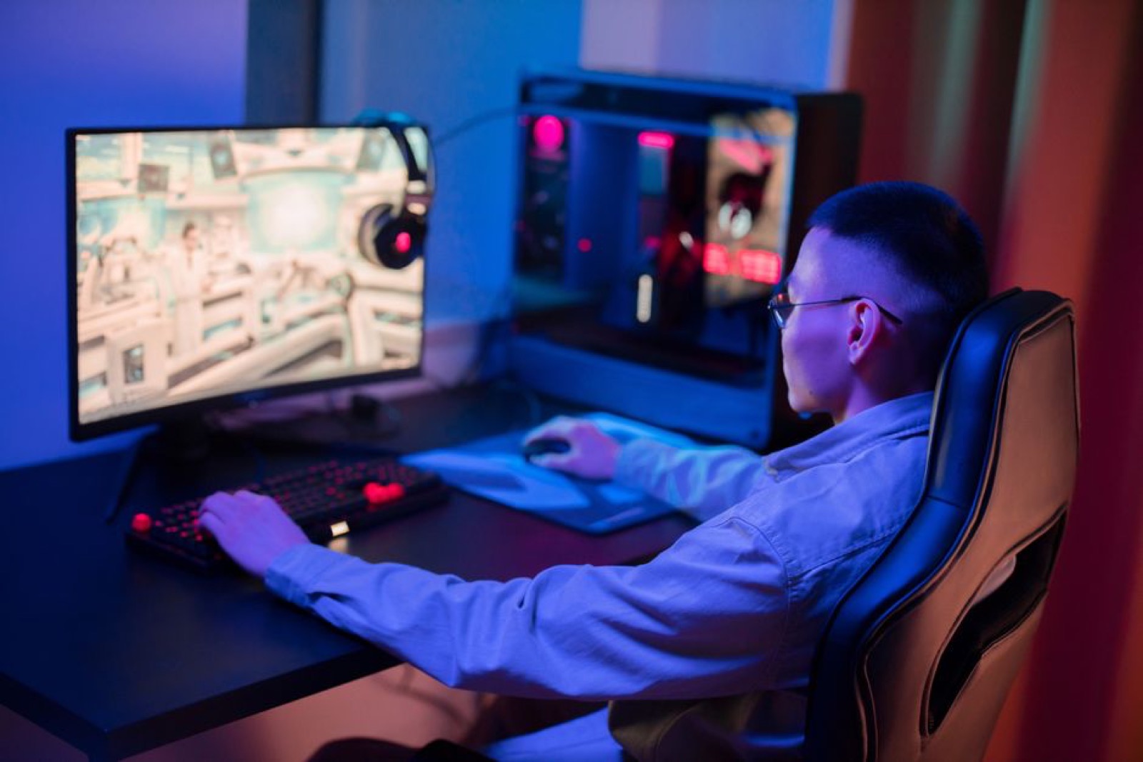 A young man gaming on a PC