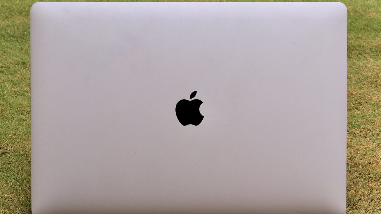 Apple MacBook Pro (2017) with monitor opened with grass as background