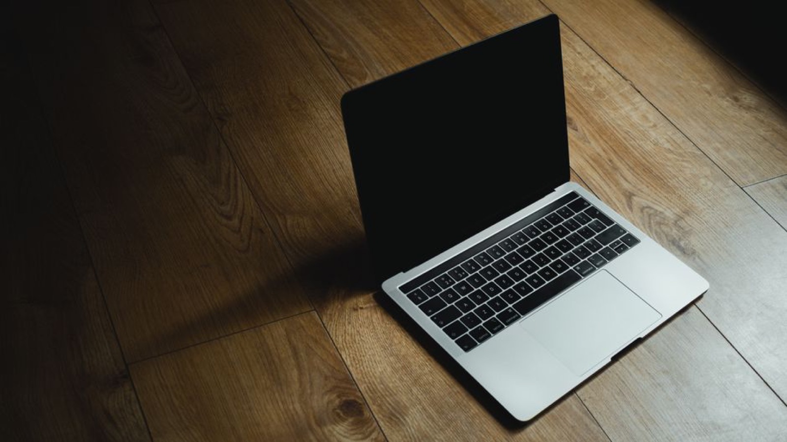 A MacBook on a wooden table