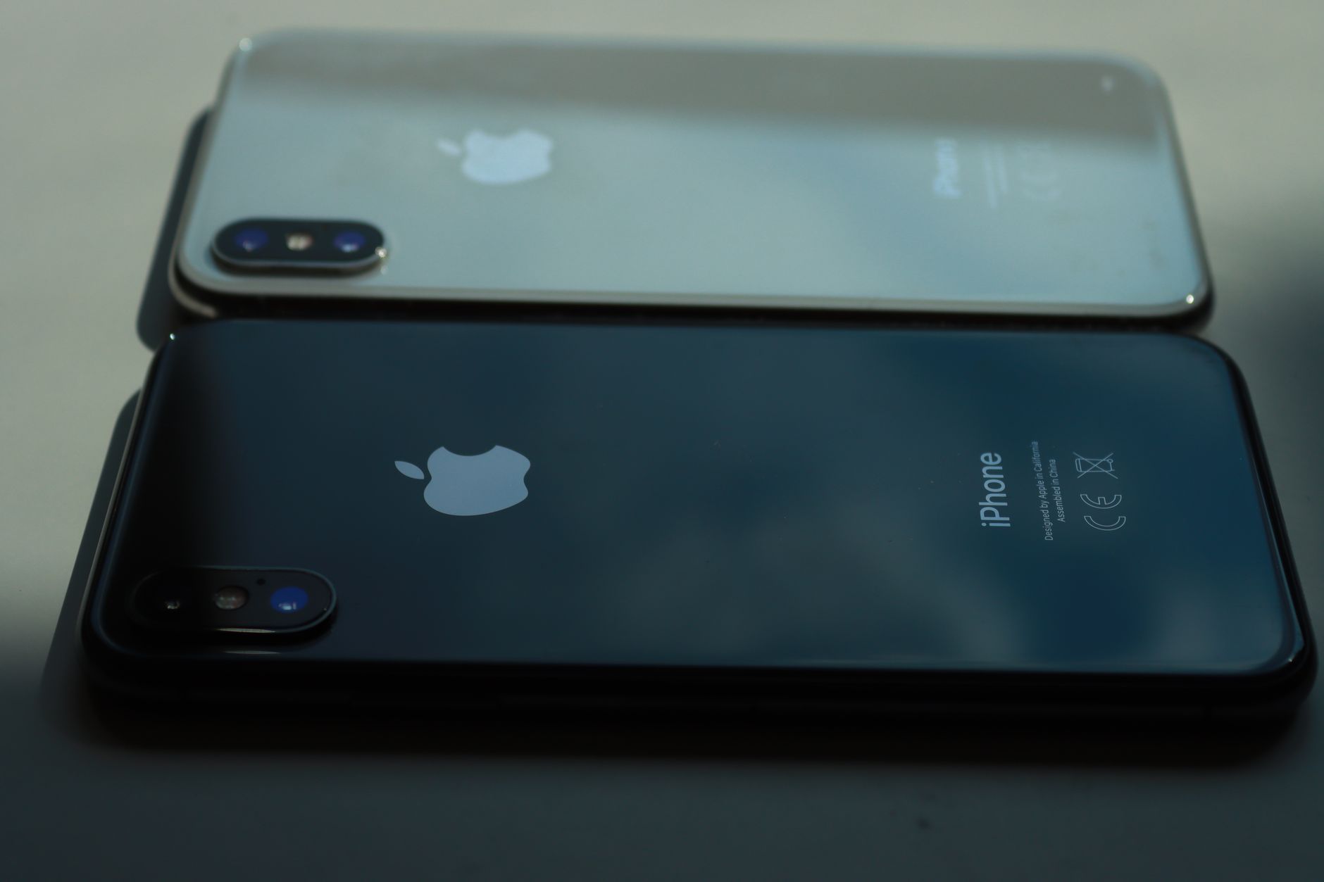 Two iPhones lying side by side