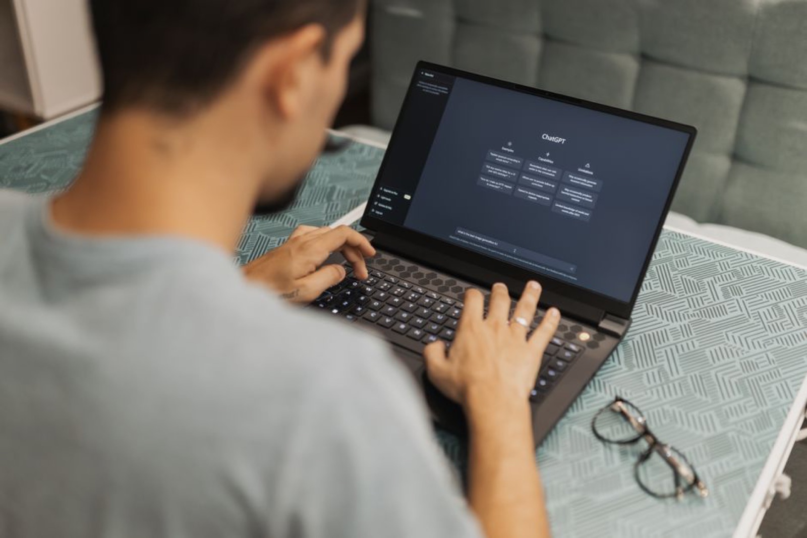 A man using a laptop with an AI interface
